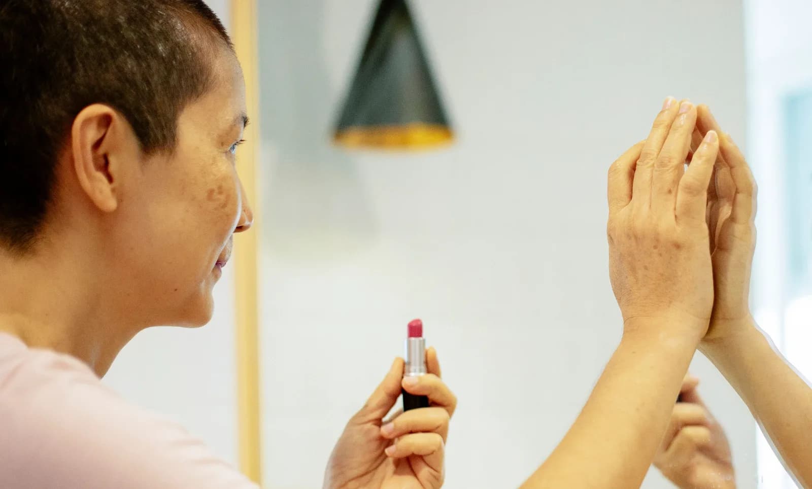 Woman looking confidently at her reflection after an aesthetic treatment in Malta