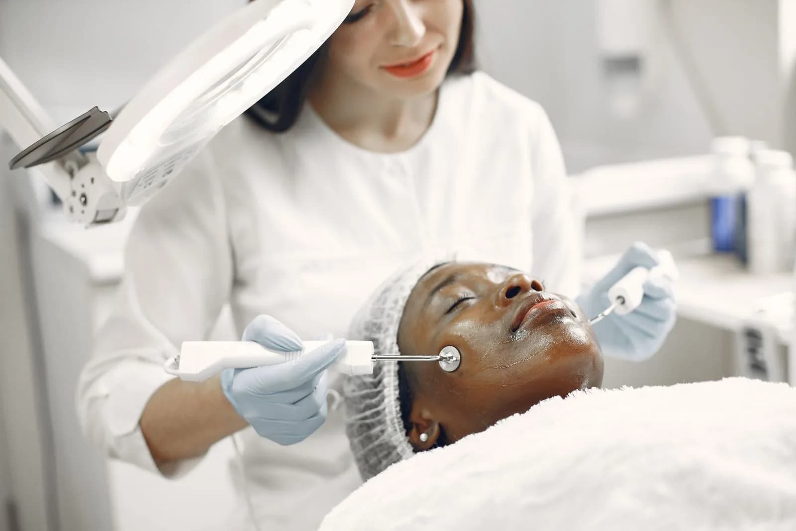 A practitioner performing a facial treatment, combining anti-wrinkle injections and fillers in a modern Malta clinic