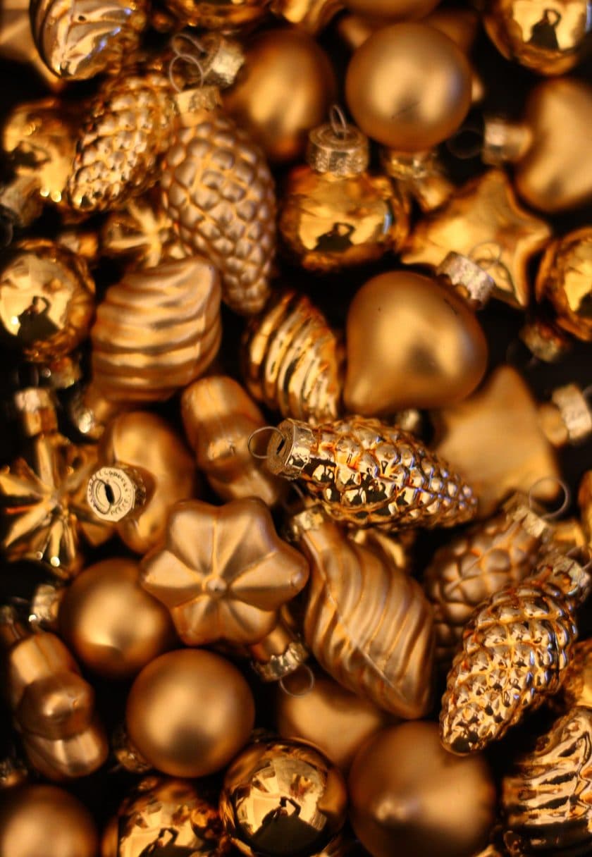 Golden Christmas baubles and pinecones — Christmas gift cards at Carisma Aesthetics Malta