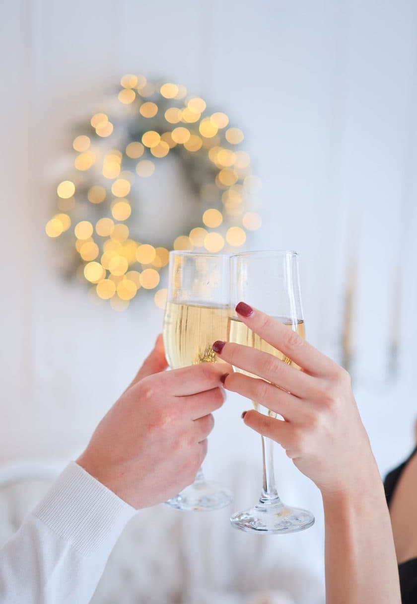 Two champagne flutes raised in a toast — Congratulations gift cards at Carisma Aesthetics Malta