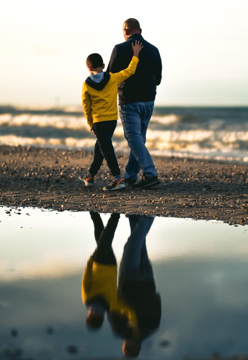 Father and son walking the shoreline at golden hour — Father's Day gift cards at Carisma Aesthetics Malta