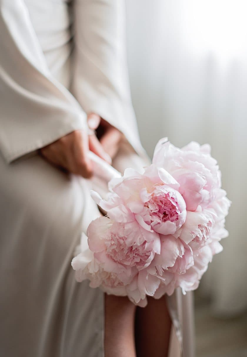 Hands holding a peony — a personalised gift voucher