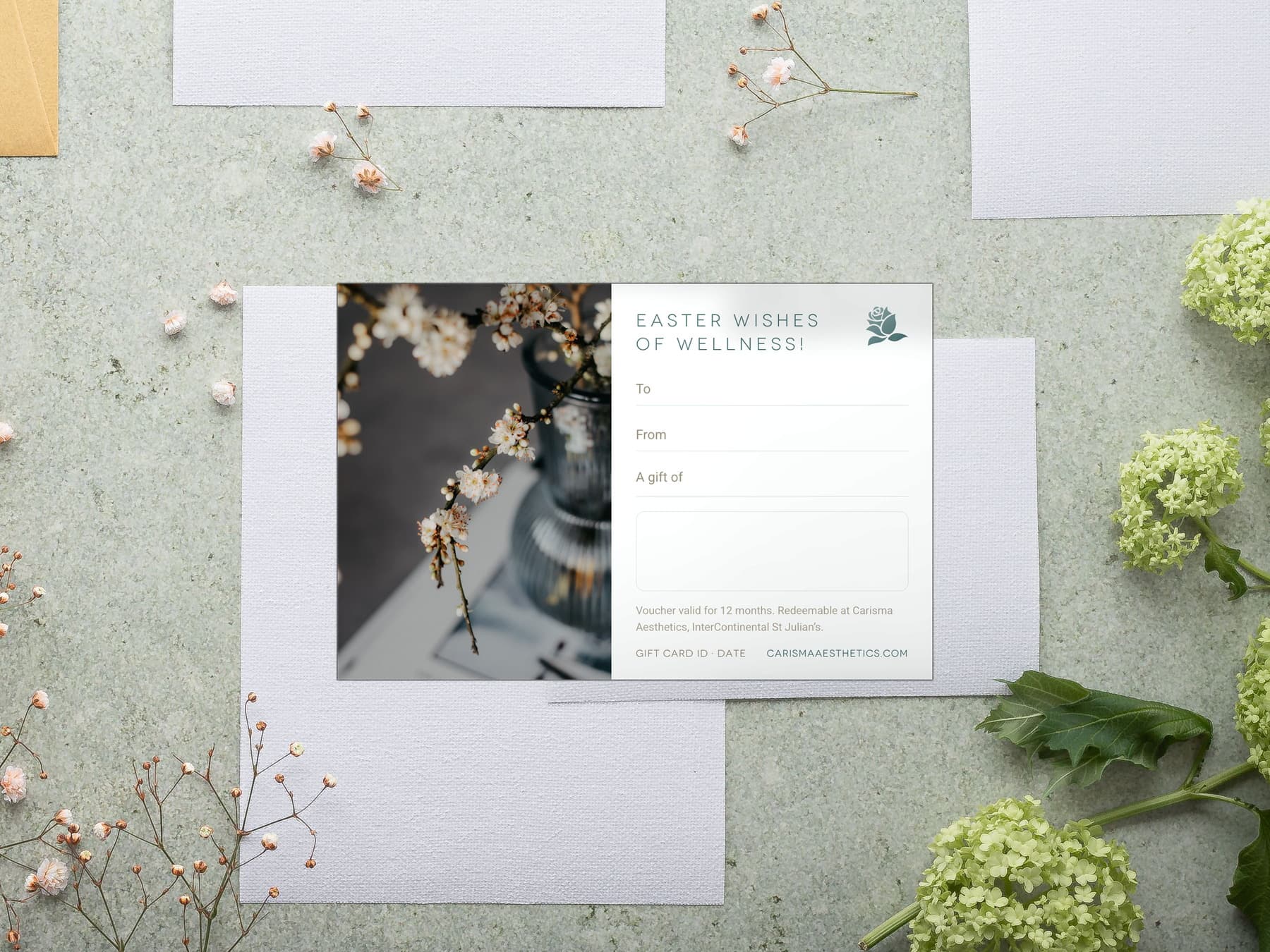 A Carisma Aesthetics Easter gift card with spring blossom on white plaster
