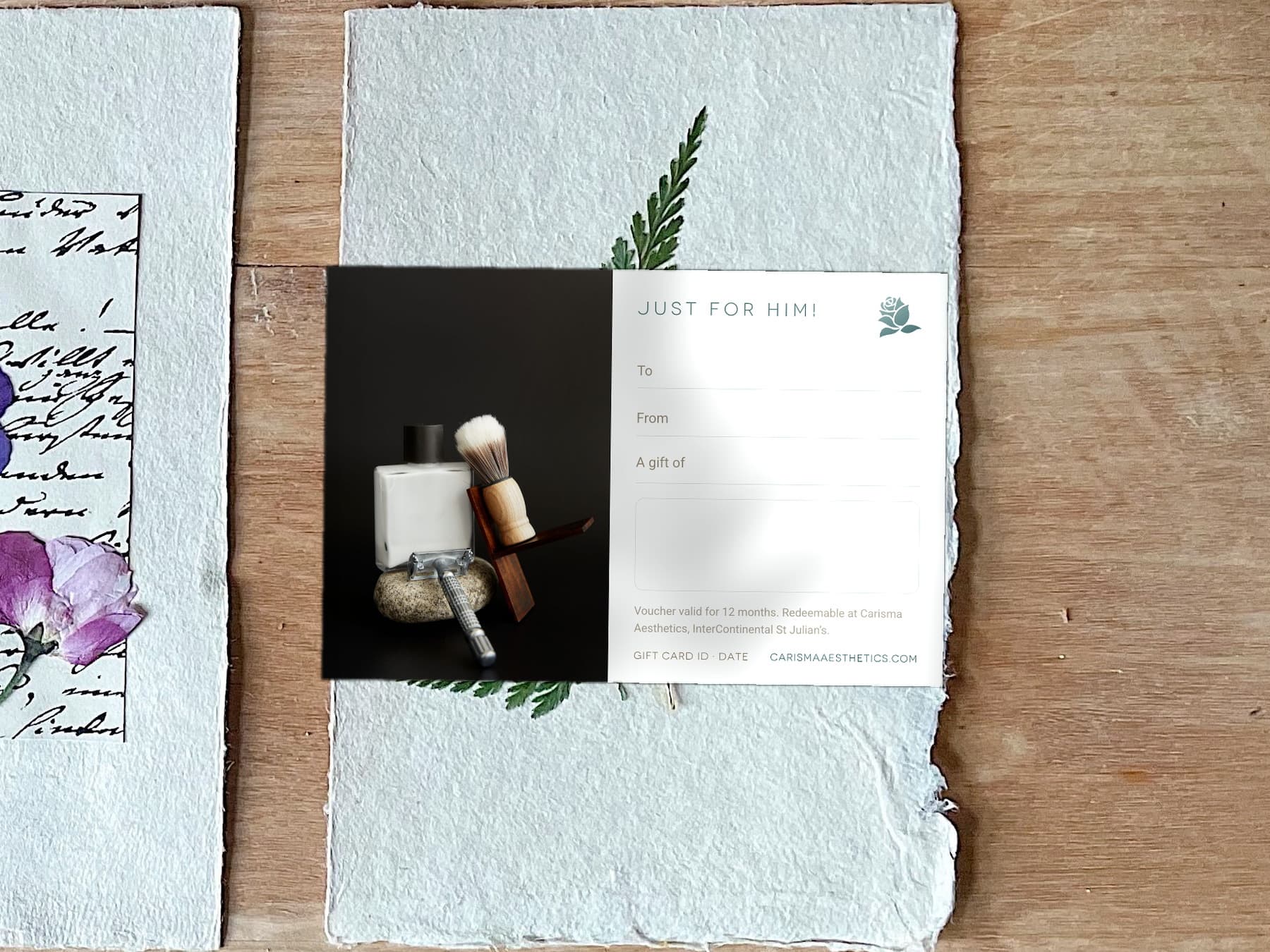 A Carisma Aesthetics Father's Day gift card on a cork coaster against cool pale stone