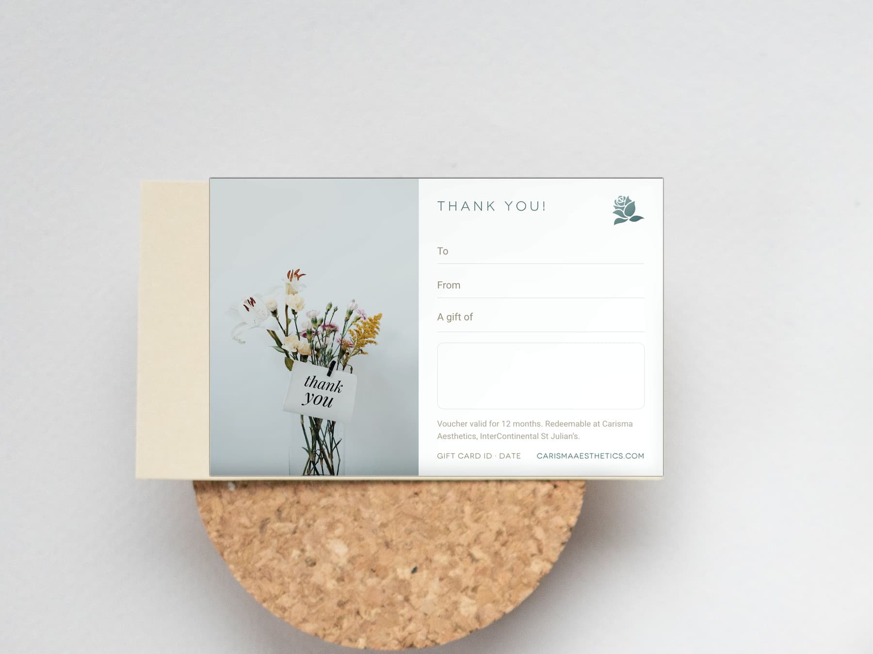 A Carisma Aesthetics thank-you gift card on a pale ceramic plate